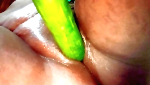Indian woman has sex with cucumber dildo on her bed