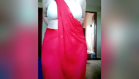 Indian solo female in red dress is licking her pussy
