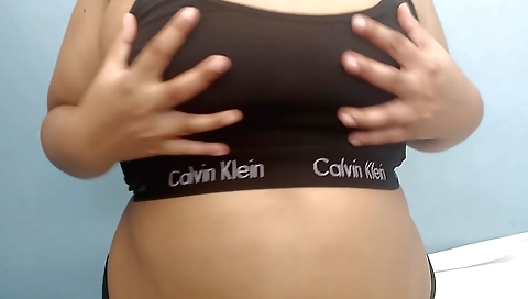Indian bhabhi in a red and black suit is making a video