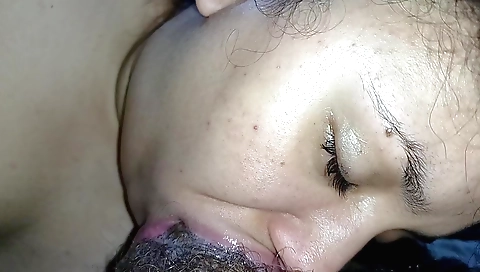 Indian chick in a white t-shirt with a black dildo in mouth