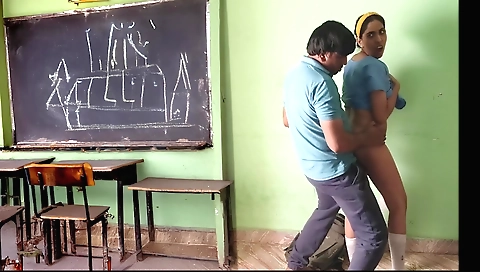 Brunette girl in an empty school class gets fucked