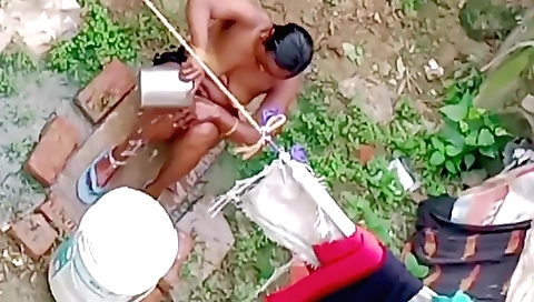 Indian babe with huge boobs goes outside to enjoy the bath